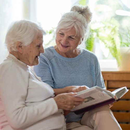 mother and daughter looking through photo album